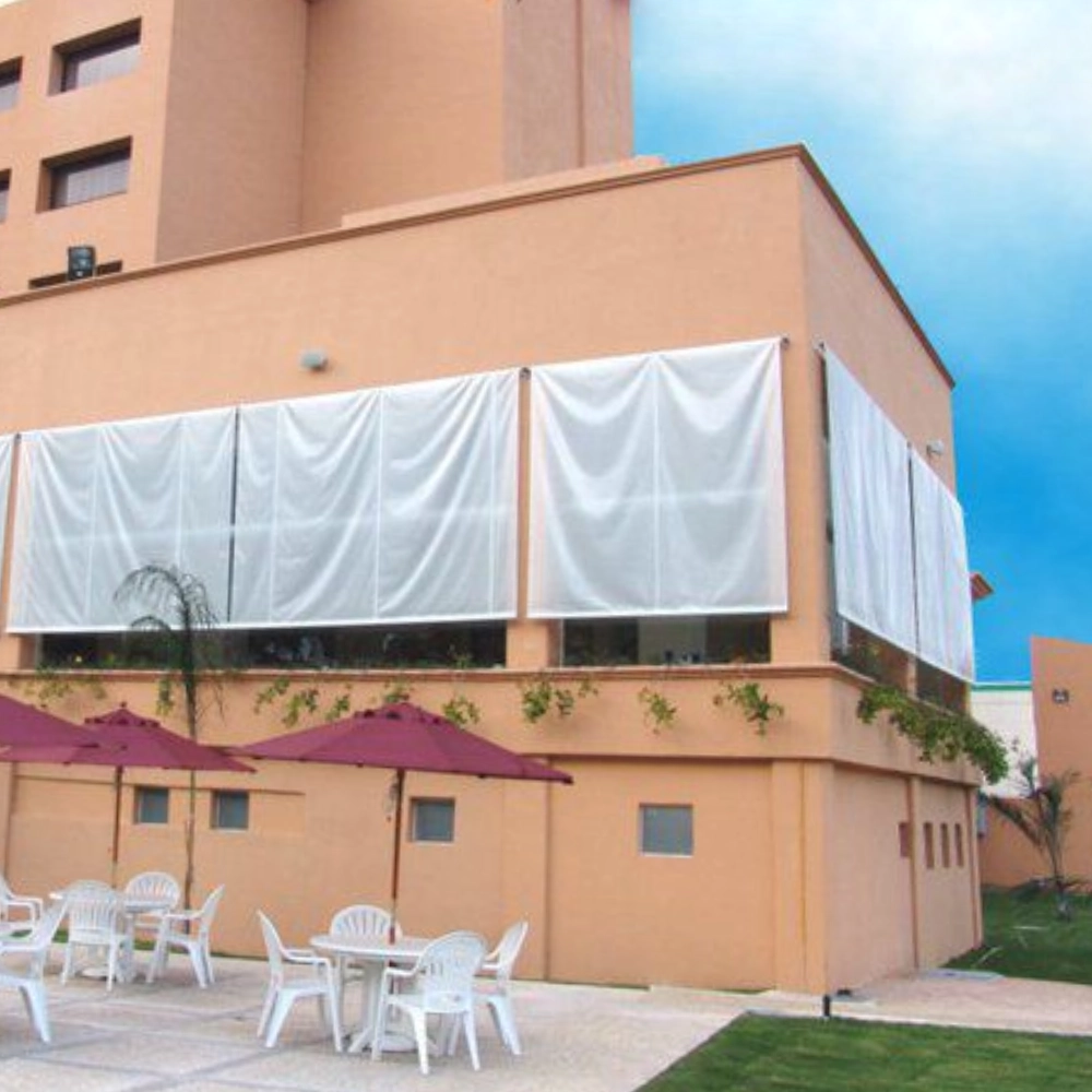Picture of window curtain-like-awnings covering the windows of a building showing the application of 18oz clear PVC coated polyester fabric