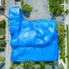Building covered in blue fumigation tarp depicting the use of 8oz PVC coated polyester fabric