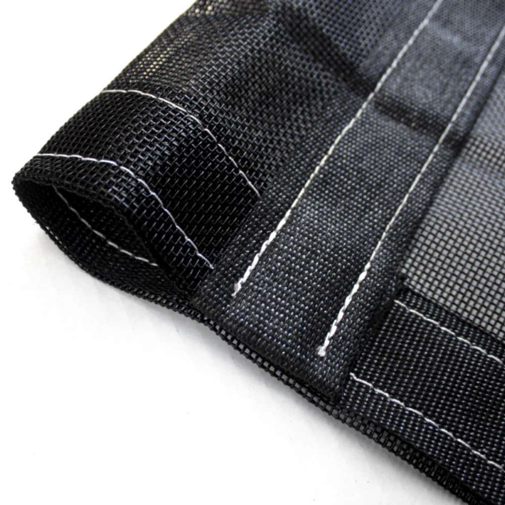 Picture of a close up of the mesh dump tarp pocket depicting the webbing reinforcement on the outside of the pocket and on the the attachment btween the pocket and the rest of the tarp.