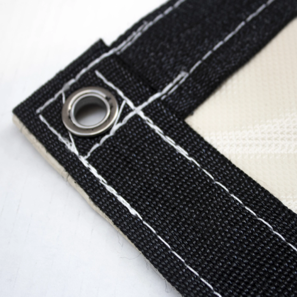 Picture of steel grommet and black webbing on a beige 10x10 18 oz multipurpose tarp